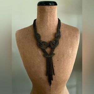 Metal necklace, bronze color. Clasp closure, adjustable length (plus/minus 2”).